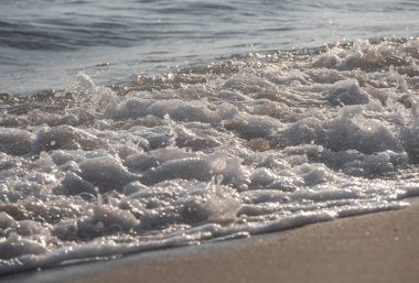 Dalgalar deniz kıyısı makrosu sıçratıyor. Yaklaş.