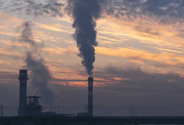 factory smoke chimney at sunrise sky clouds