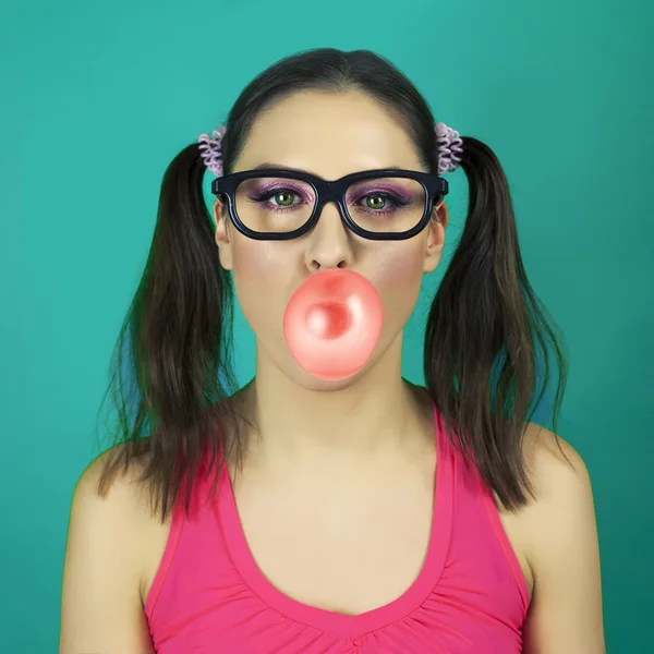 Funny  girl wearing  glasses with bubble of chewing gum