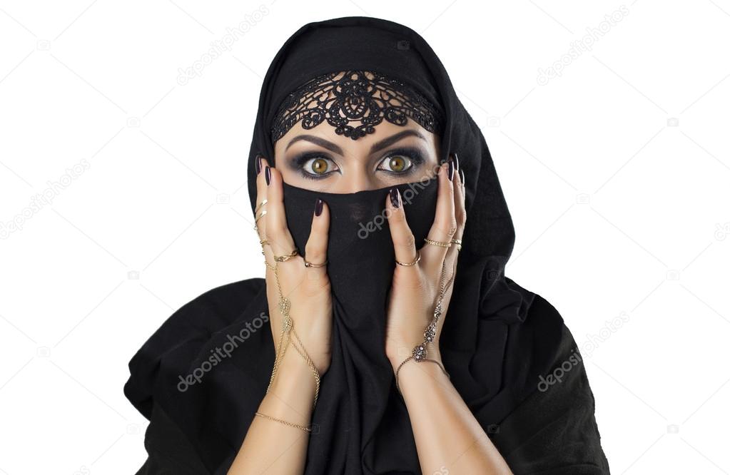 Young caucasian woman with black veil on face frightened