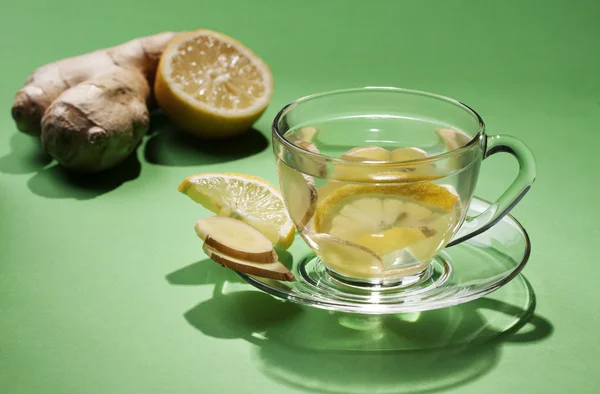 Ginger tea in a cup of glass on a green background. — Stock Photo, Image