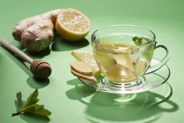 Ginger tea in a cup of glass on a green background. — Stock Photo, Image