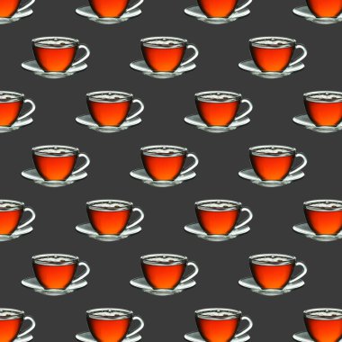 Gri zemin üzerinde çay olan desenli cam bardak.