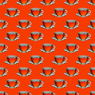 Turuncu zemin üzerinde çay olan desenli cam bardak.