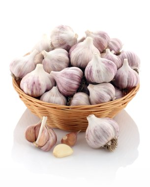 garlic in a wicker basket on a white background clipart
