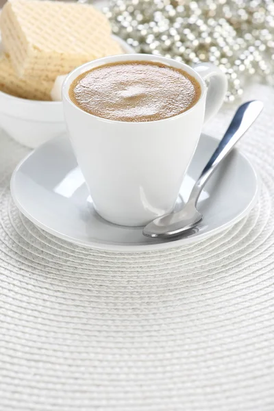 Cup of coffee  on a white wicker a mat — Stock Photo, Image