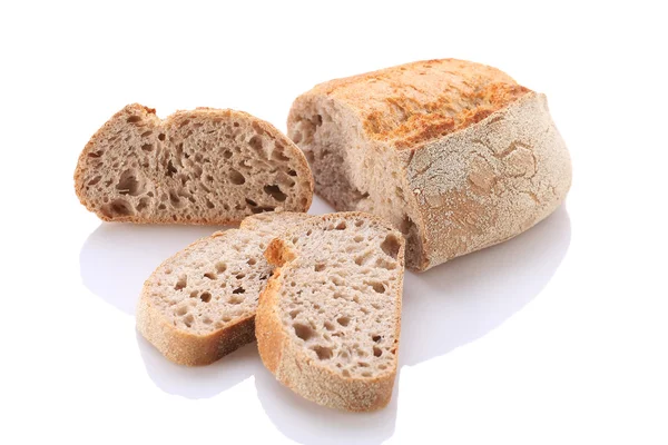 Loaf and slices of bread on a white background — Stock Photo, Image