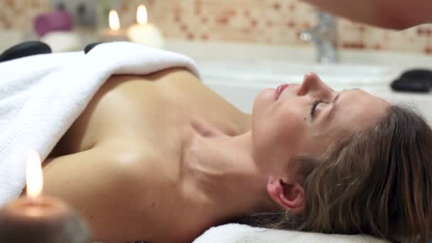 Женщина наслаждается каменной терапией. Женщина получает расслабляющее массажное лечение. — стоковое видео