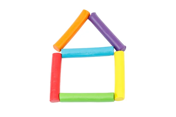 Colorful rod plasticine arranging in house shape on white backgr — Stock Photo, Image