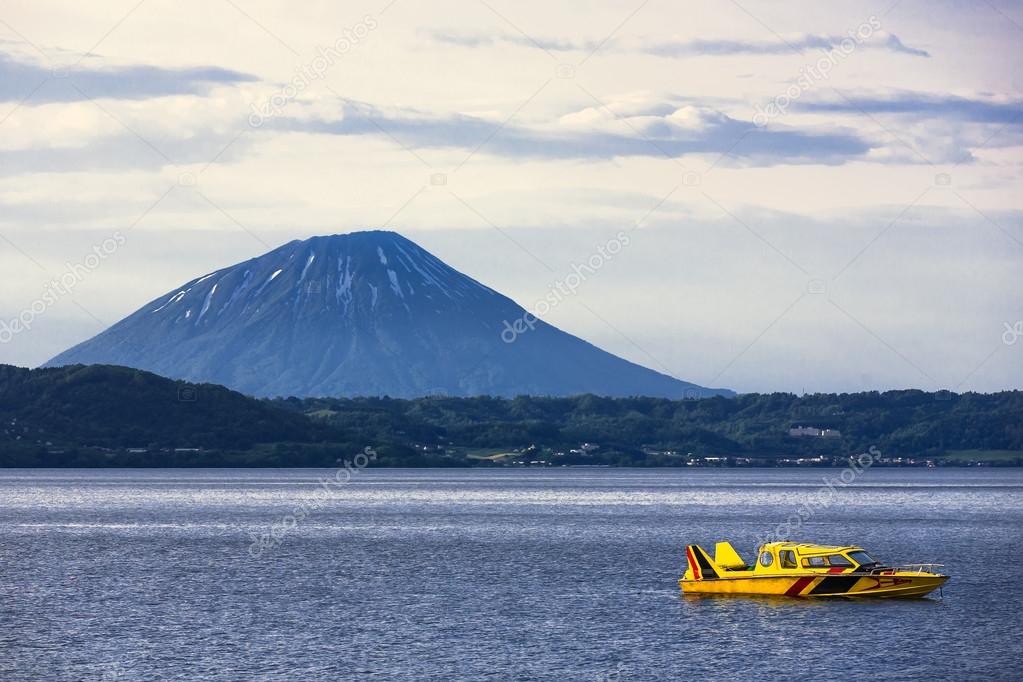 Cruising at Lake Toya with mountain in background, Hokkaido, Jap