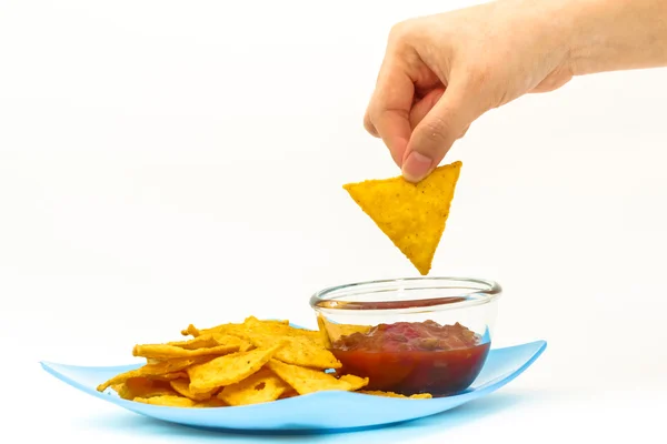 Dipping tortilla chips with salsa sauce in dish on white backgro — Stock Photo, Image