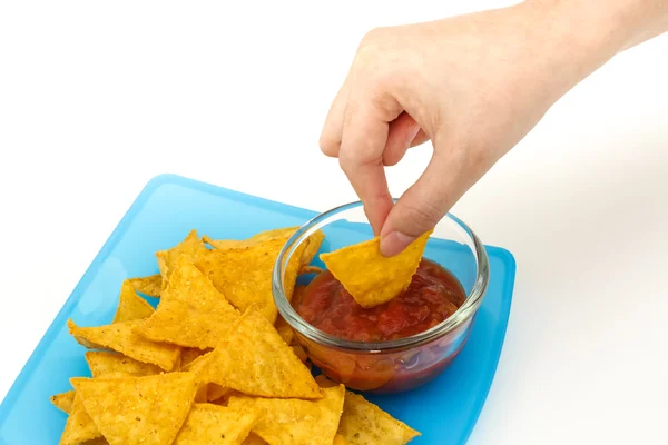 Dipping tortilla chips with salsa sauce in dish on white backgro — Stock Photo, Image