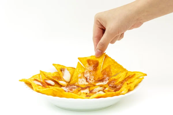 Pincking tortila chips covered with cheese (Nachos) from white d — Stock Photo, Image