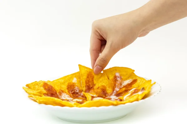 Pincking tortila chips covered with cheese (Nachos) from white d — Stock Photo, Image