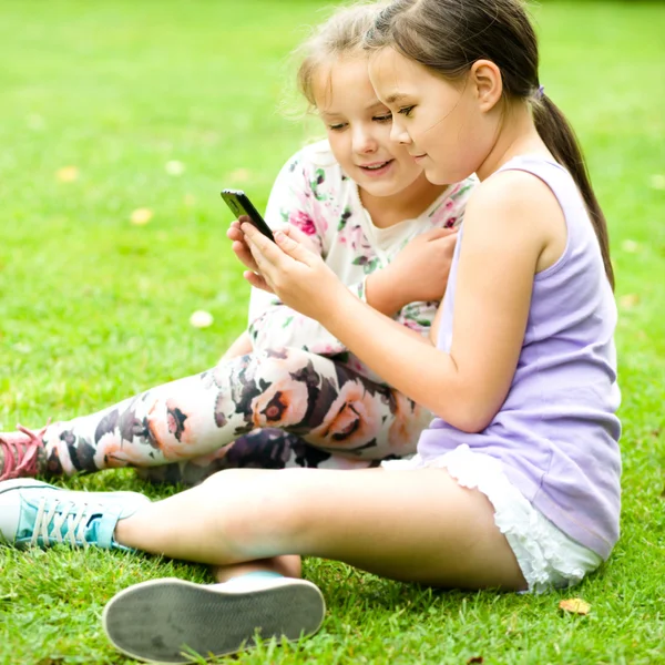 Girl with tablet at the park — Stock Photo, Image