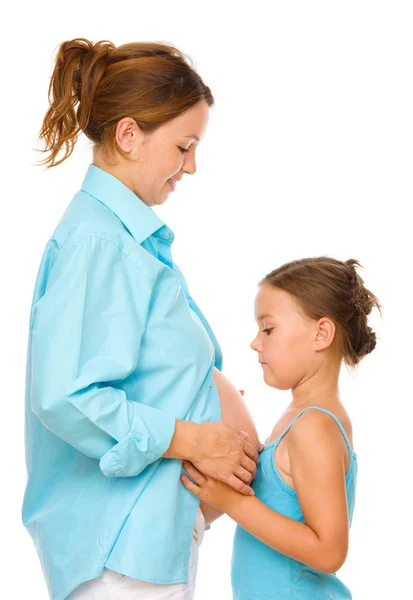 Happy child holding belly of pregnant woman — Stock Photo, Image