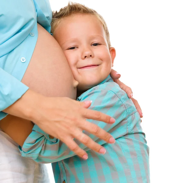 Happy child holding belly of pregnant woman Stock Picture