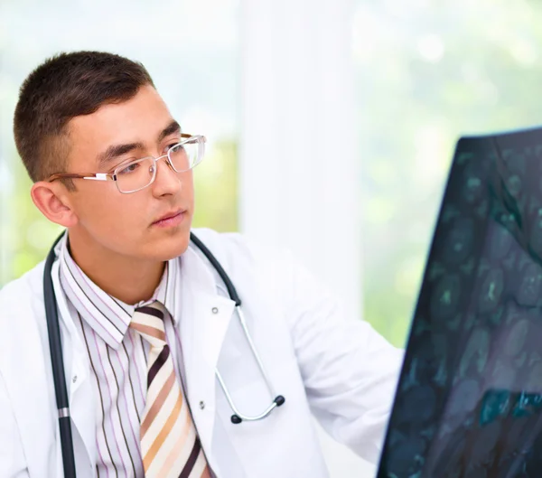 Joven médico mirando la tomografía cerebral —  Fotos de Stock