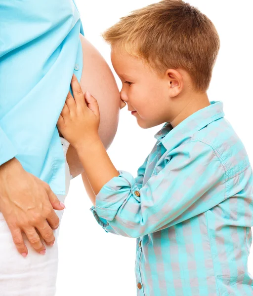 Happy child holding belly of pregnant woman Stock Photo
