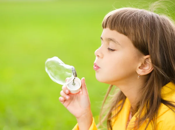 Little girl blowing soap bubbles — Stock Photo, Image