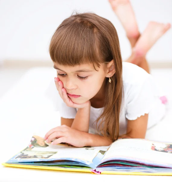 Little girl is reading a book Stock Photo