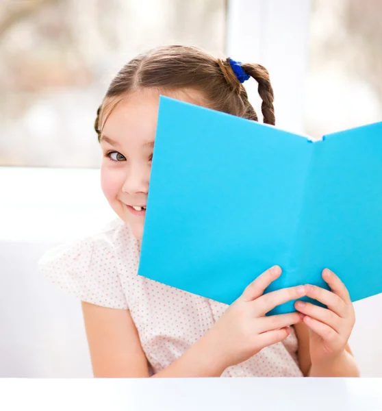 Little girl is playing with book — Stock Photo, Image