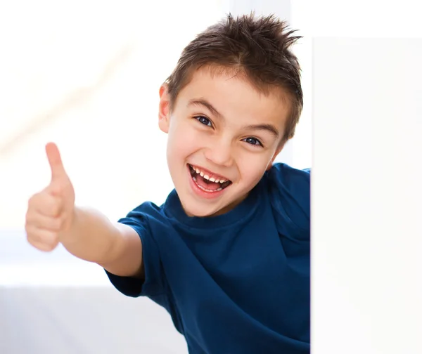 Cute boy is holding blank banner — Stock Photo, Image