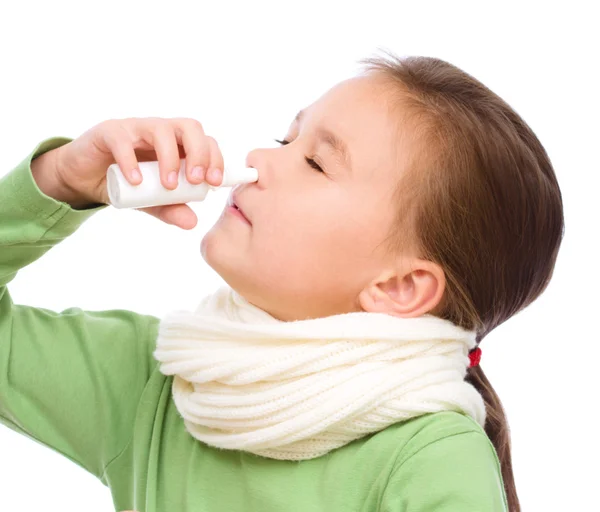 Cute girl spraying her nose — Stock Photo, Image