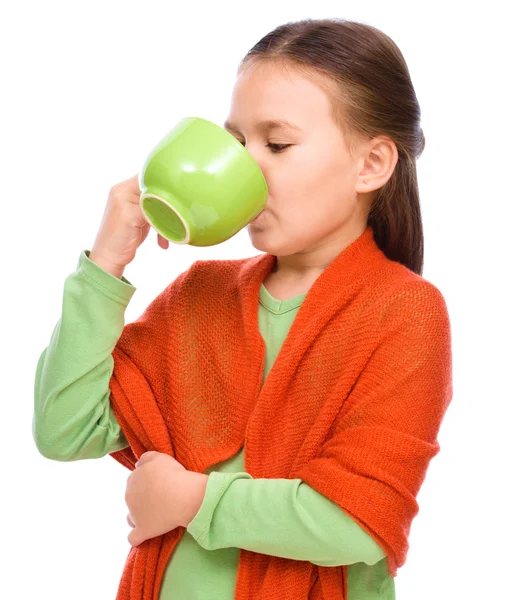 Cute girl is drinking tee — Stock Photo, Image