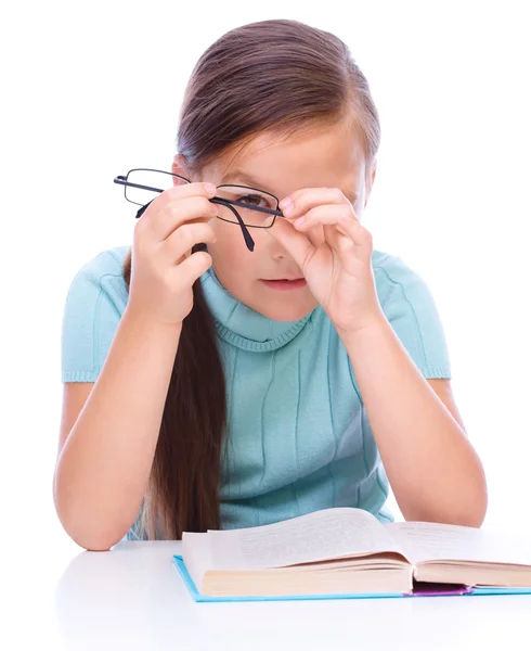 Cute girl is reading book — Stock Photo, Image