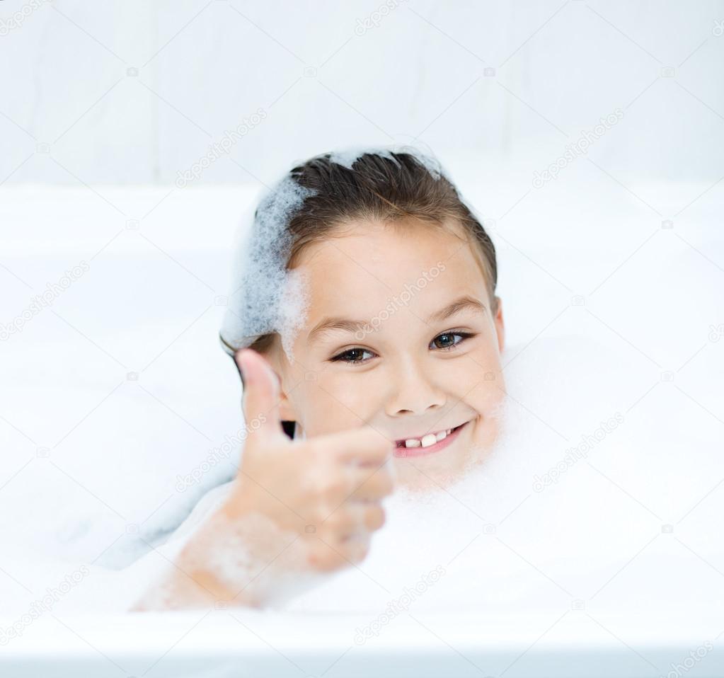 Girl bathes in a bathroom