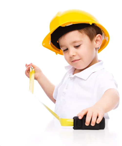 Boy as a construction worker with tape measure — Stock Photo, Image