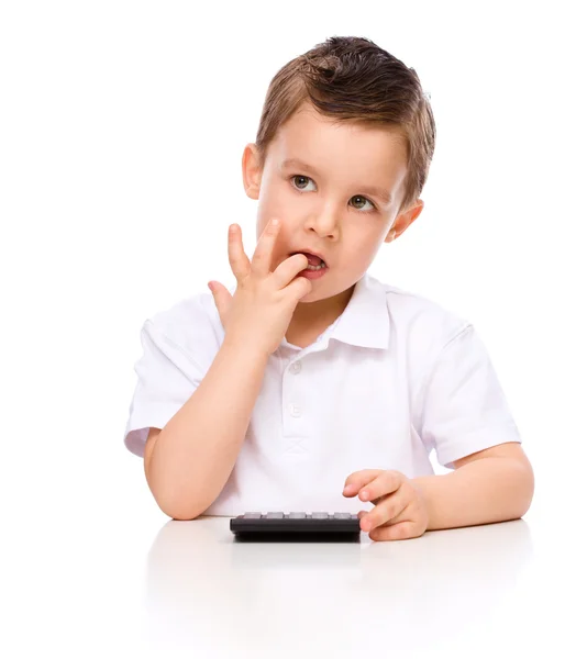 Cute boy is using calculator — Stock Photo, Image