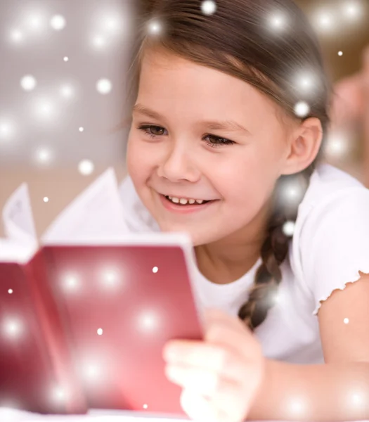 Little girl is reading a book — Stock Photo, Image