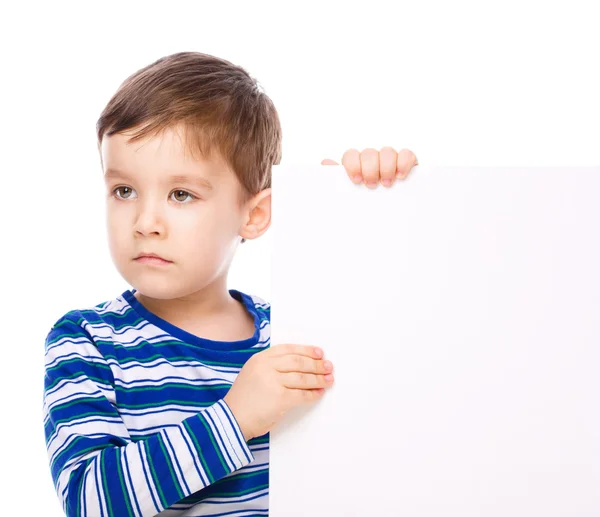 Cute boy is holding blank banner — Stock Photo, Image