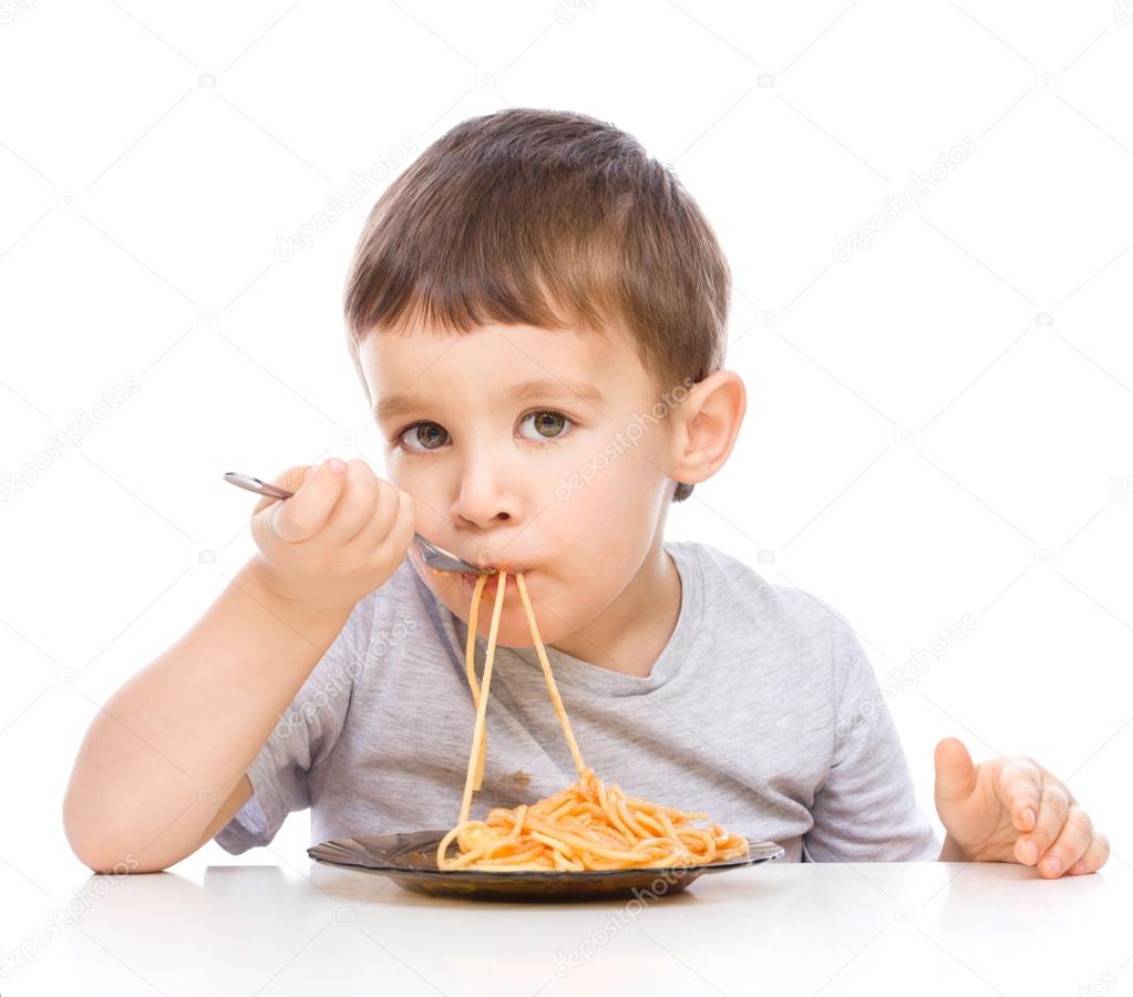 Little boy is eating spaghetti