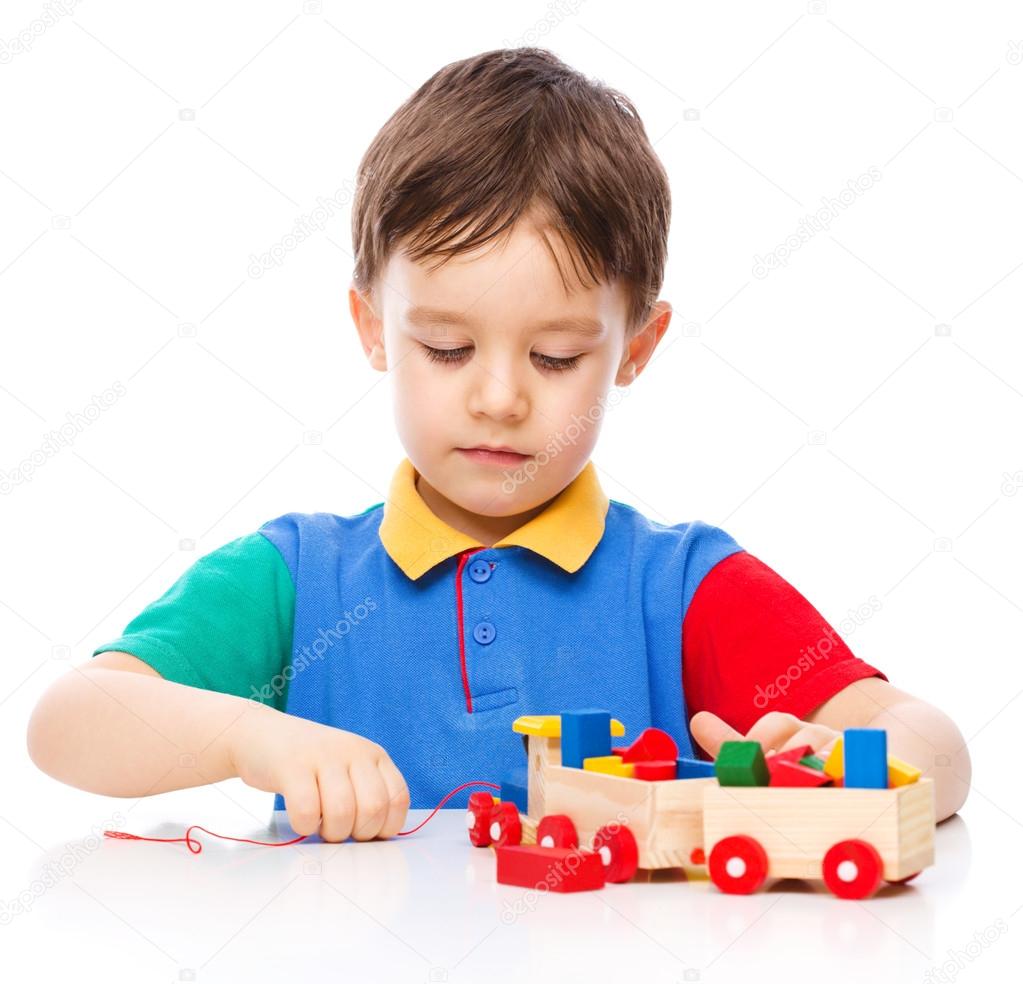 Boy is playing with building blocks