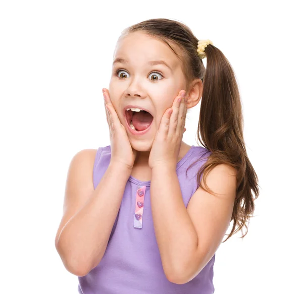 Cute girl is holding her face in astonishment — Stock Photo, Image