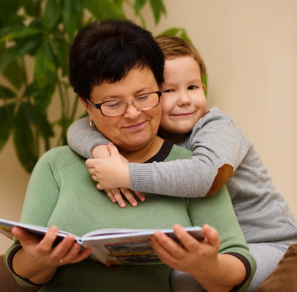 Grandmother is reading book with her grandson — Stock Photo, Image