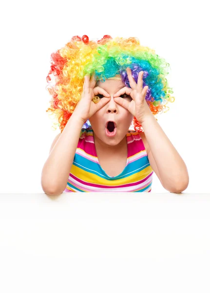 Girl in clown is holding blank banner — Stock Photo, Image