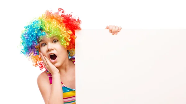 Girl in clown is holding blank banner — Stock Photo, Image