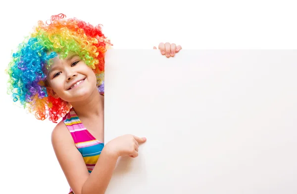 Girl in clown is holding blank banner — Stock Photo, Image