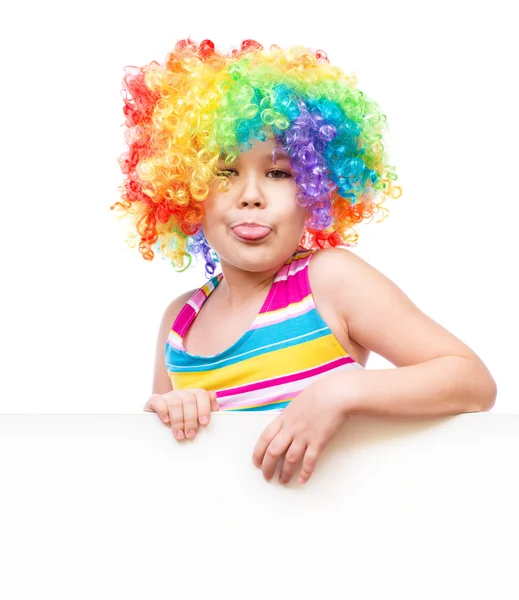 Girl in clown is holding blank banner — Stock Photo, Image