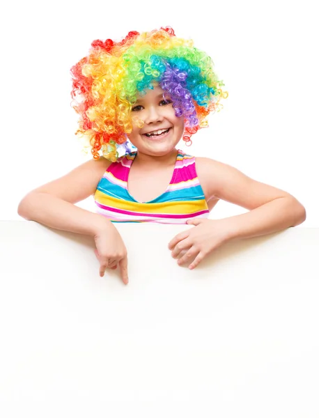 Girl in clown is holding blank banner — Stock Photo, Image