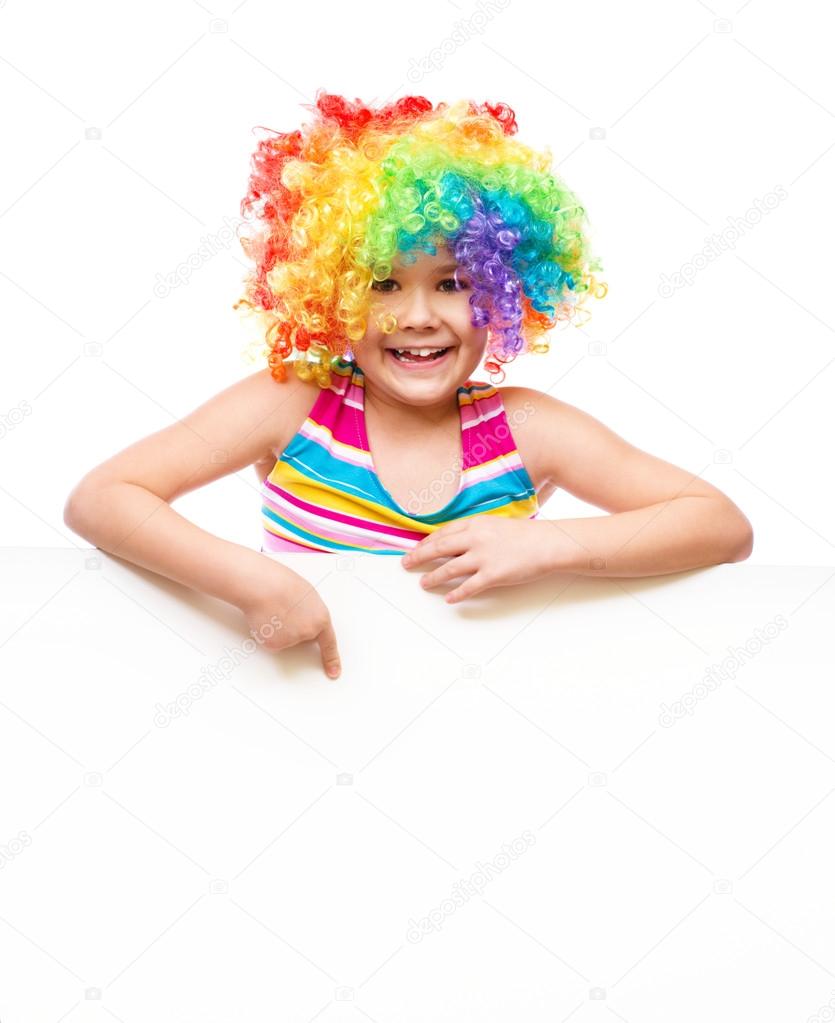 Girl in clown is holding blank banner
