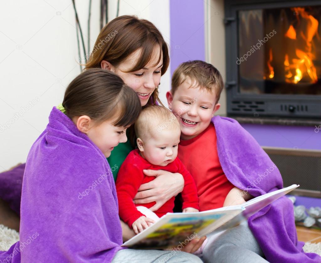 Mother is reading book with children