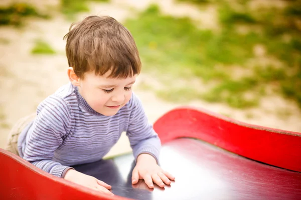 Kleiner Junge spielt auf Spielplatz — Stockfoto