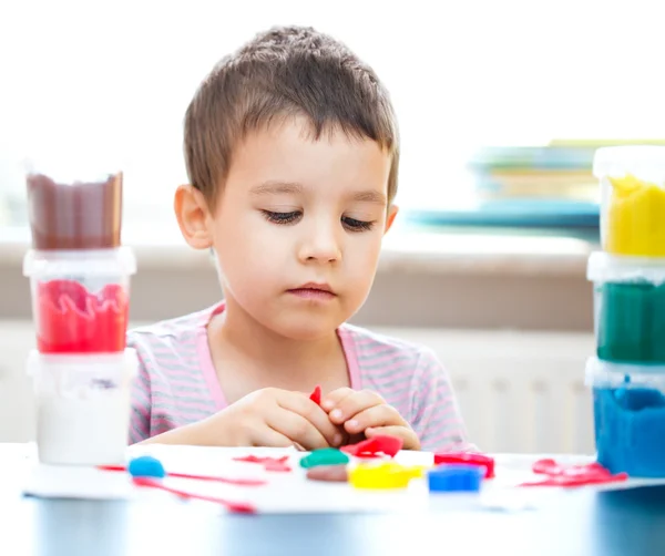 Boy playing with color play dough — Stock Photo, Image