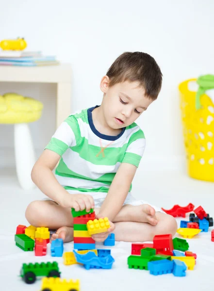 Chico está jugando con bloques de construcción — Foto de Stock