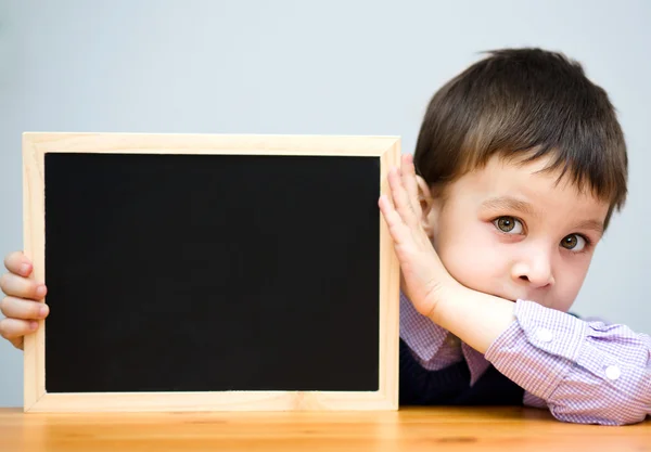 Cute boy is holding blackboard — Stock Photo, Image